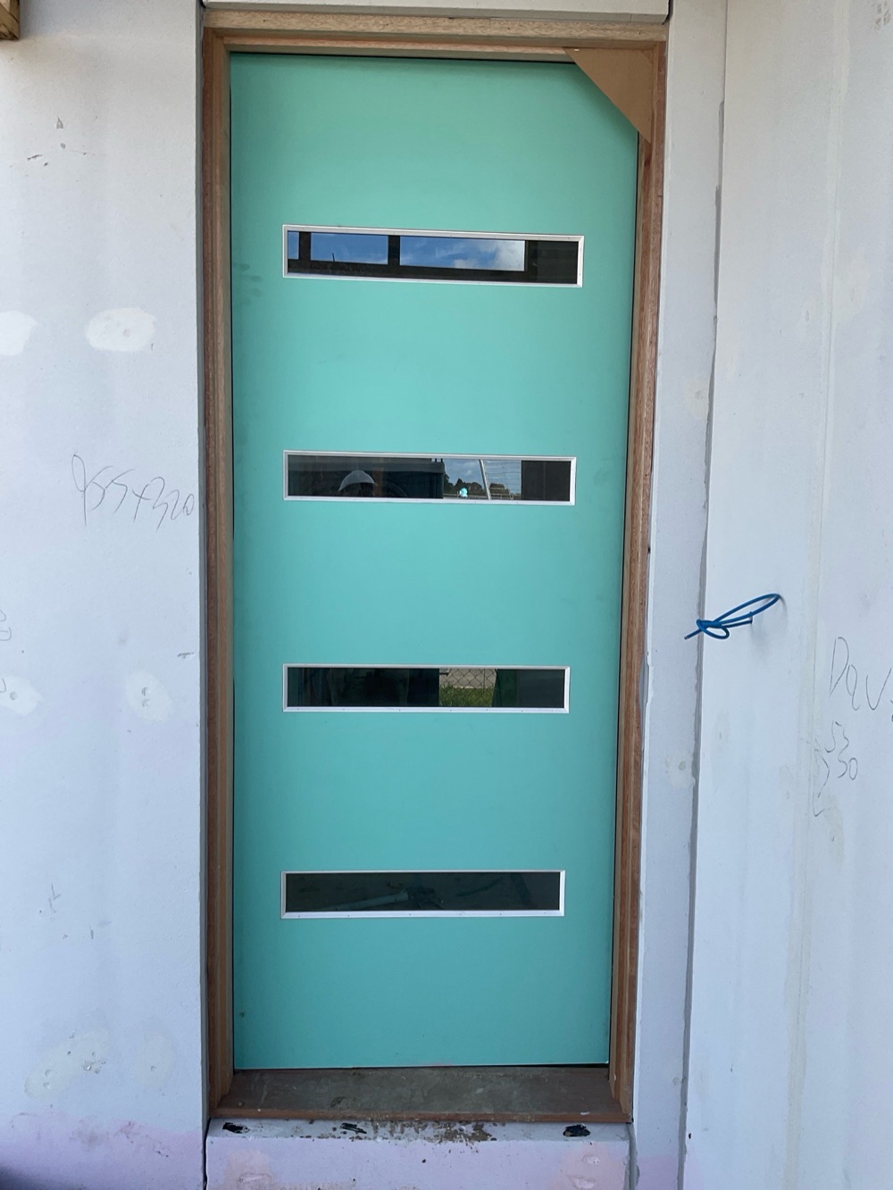 No flashing under the external doors, found during a lock-up inspection in Clyde