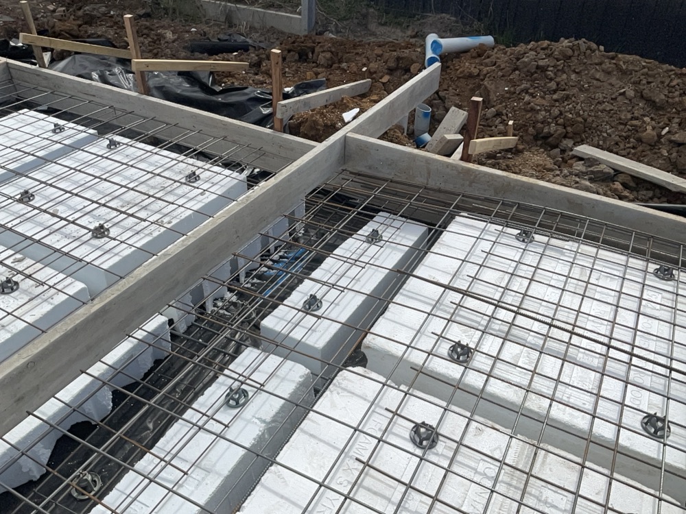 Slab mesh sagging between bar chairs, reducing cover, found during a slab pre-pour inspection in Clyde North